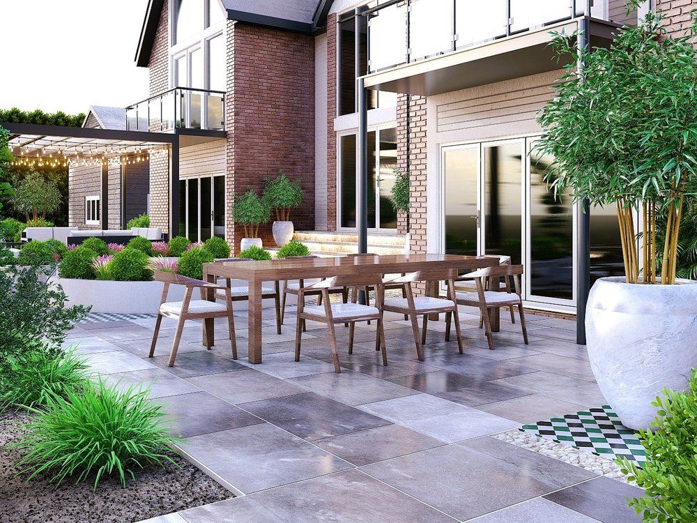 Design visual of a porcelain dining terrace with a long table, planting and a statement pot linking the house to the wider garden