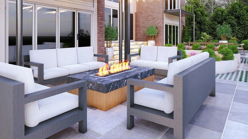 Design visual of a granite fire table with lit burner, surrounded by seating on porcelain paving