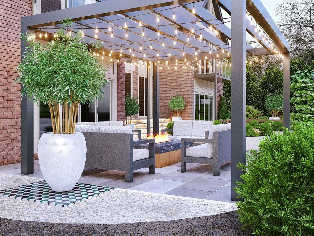 Design visual of an open-top gazebo with festoon lighting, seating, a fire table and a large statement pot on porcelain paving