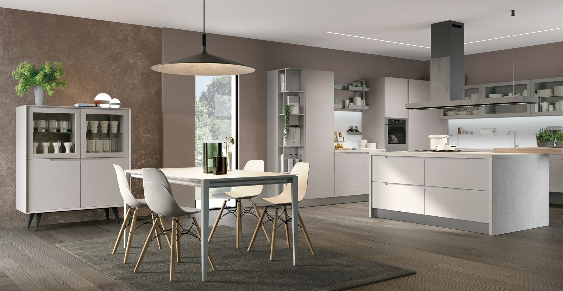 Cucina e sala da pranzo moderne con mobili grigio chiaro, isola, tavolo, sedie e parete testurizzata dai toni neutri.