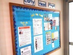 Bulletin board with blue background and Early Head Start information.