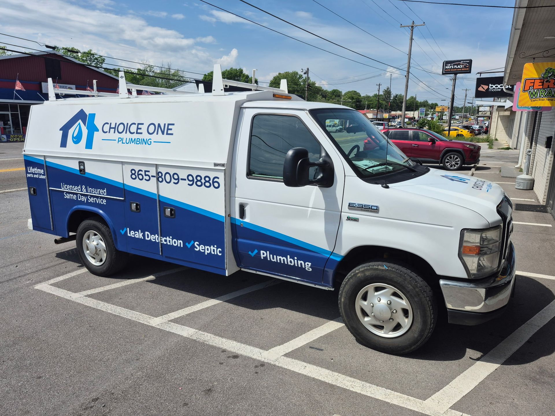 White and blue service truck with “Grove One” branding parked on a street in daylight