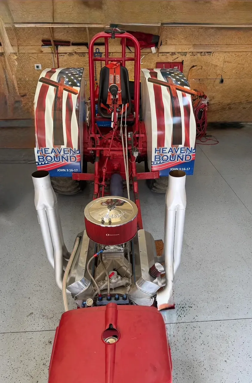 Red and white rocket-shaped vehicle or kart in a garage, front view