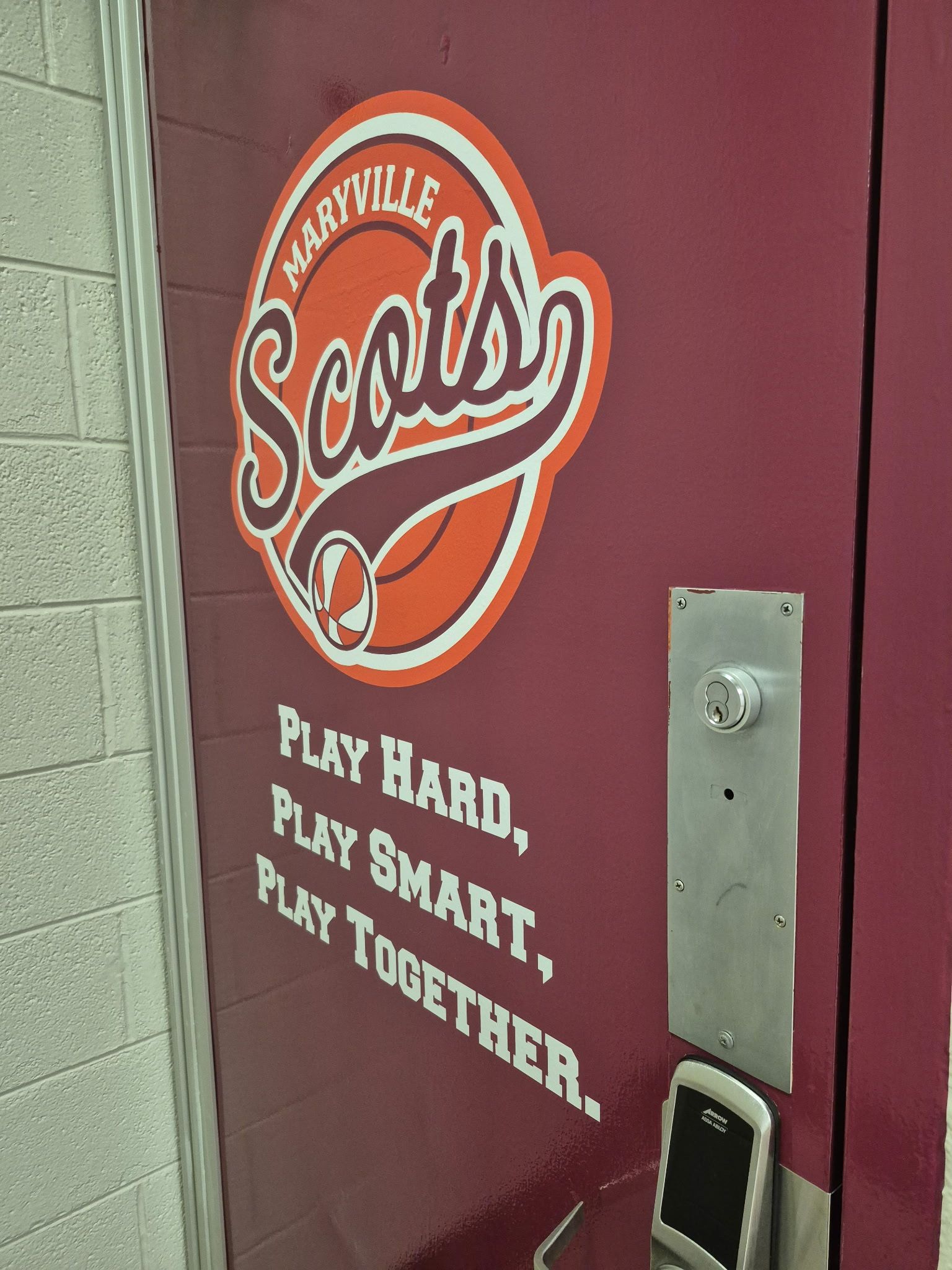 Maroon locker room door with Northville Scouts logo and motto: “Play hard, play smart, play together.”