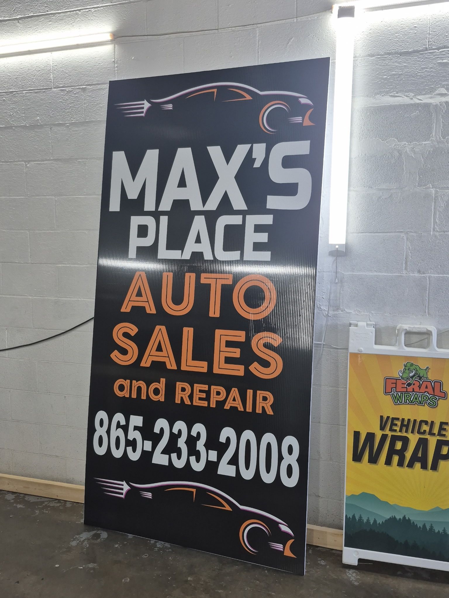 Max’s Place Auto Sales and Repair sign with phone number 865-233-2008 on a black and orange banner