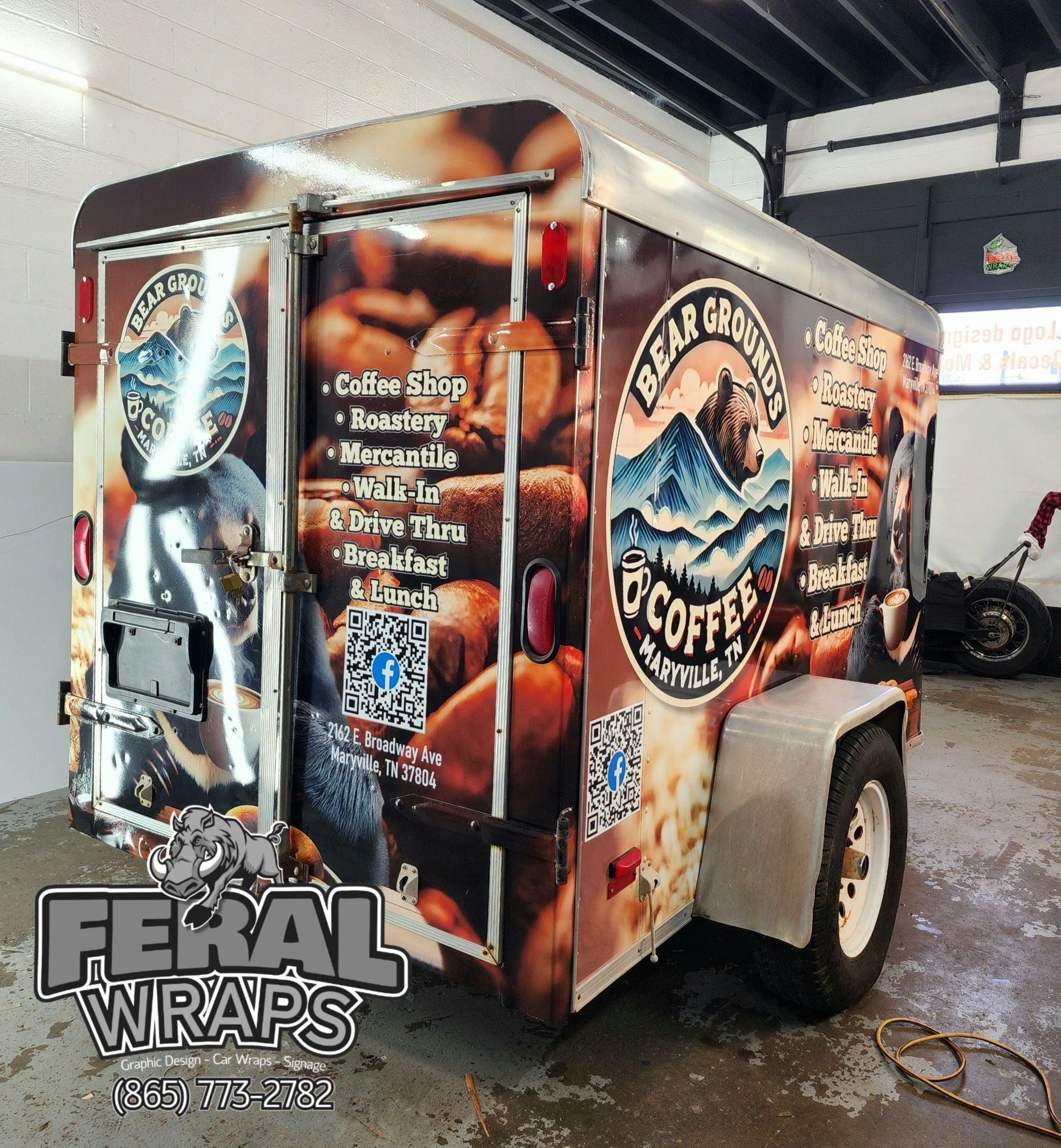 A trailer with a wrap that says feral wraps on it