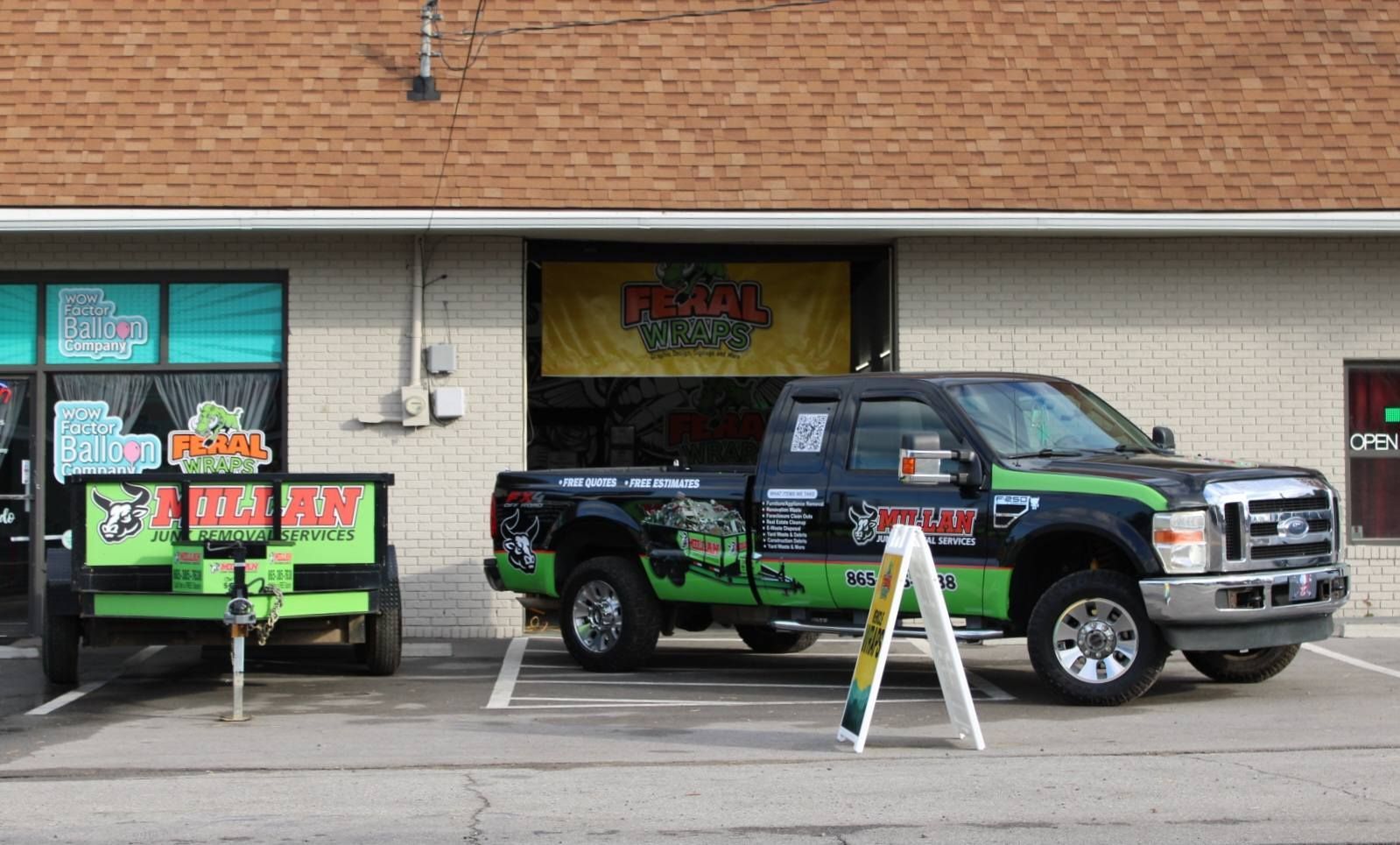 Two trucks are parked in front of a building.