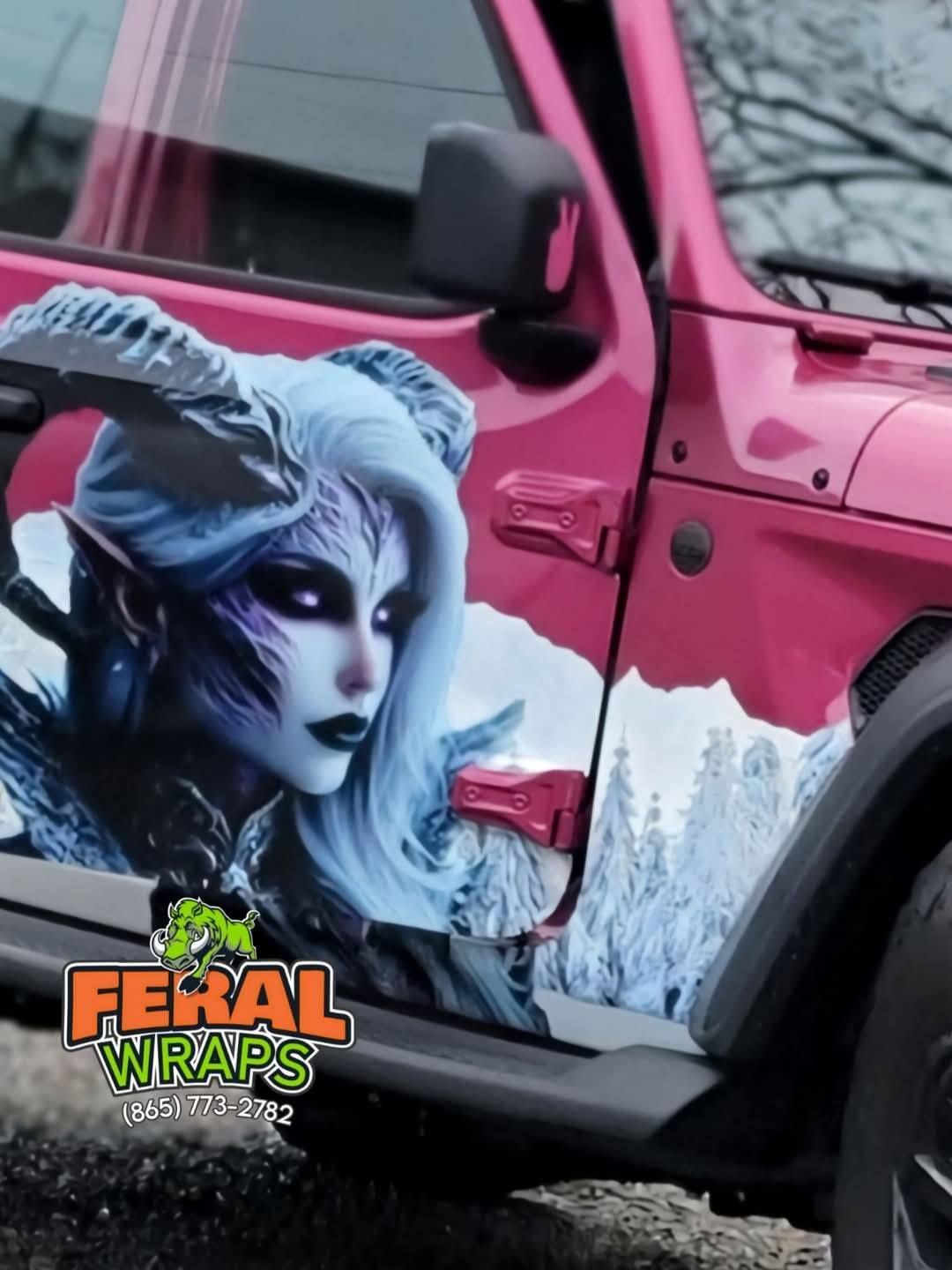 A pink jeep with a picture of a demon on the side
