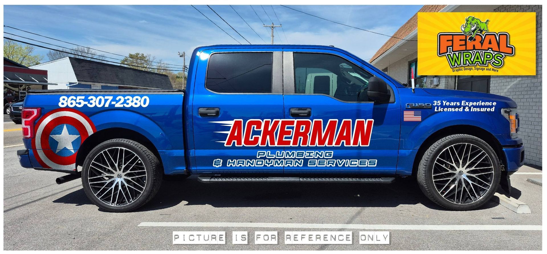 A blue ackerman truck is parked in a parking lot
