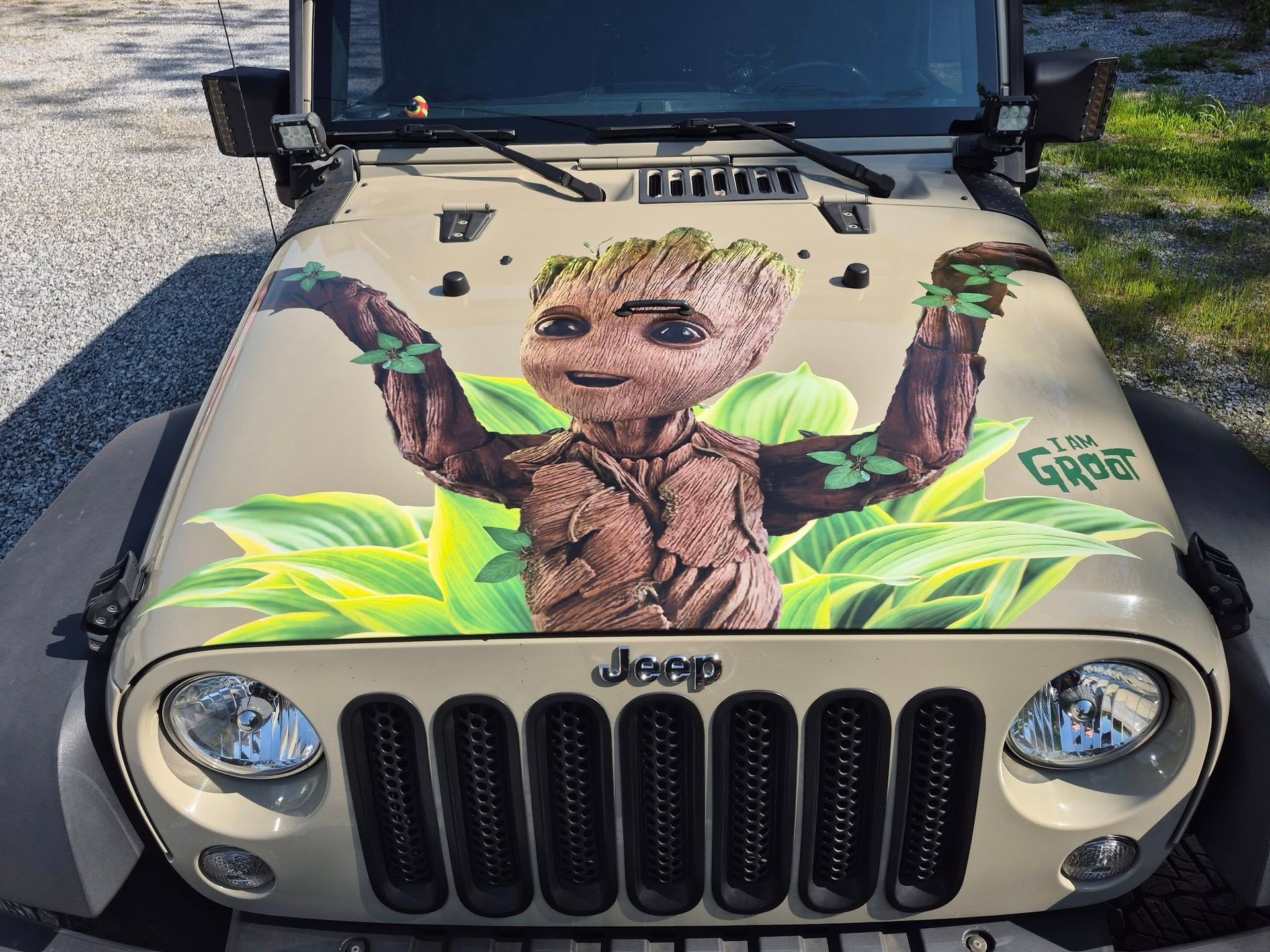 A jeep with a painting of groot on the hood