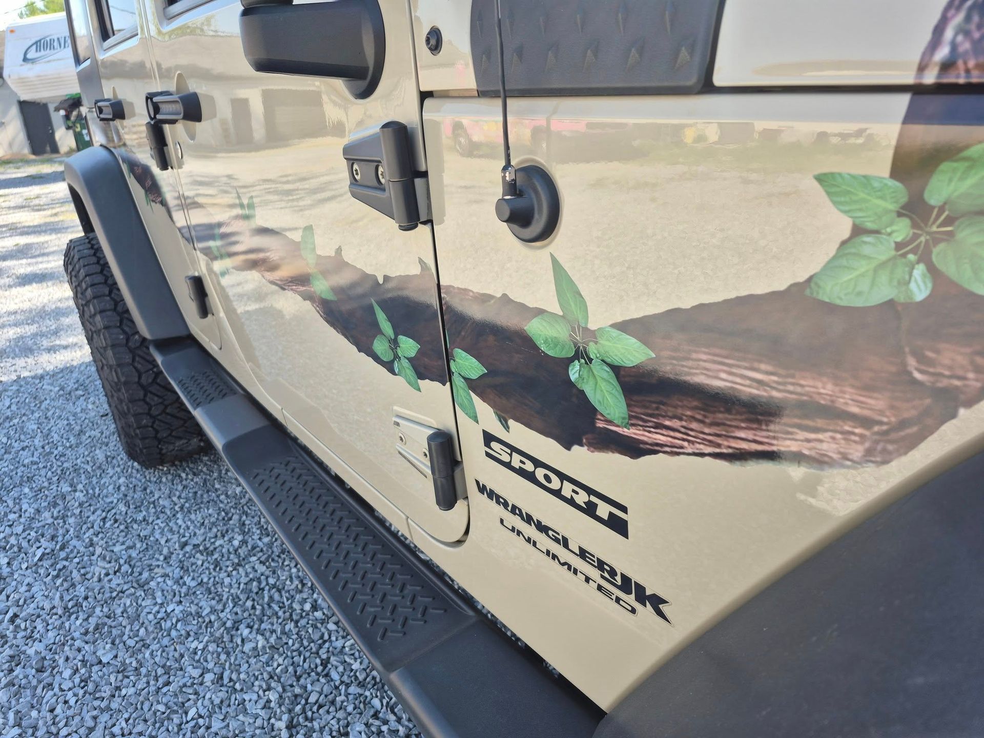 A jeep with a picture of a tree on the side of it