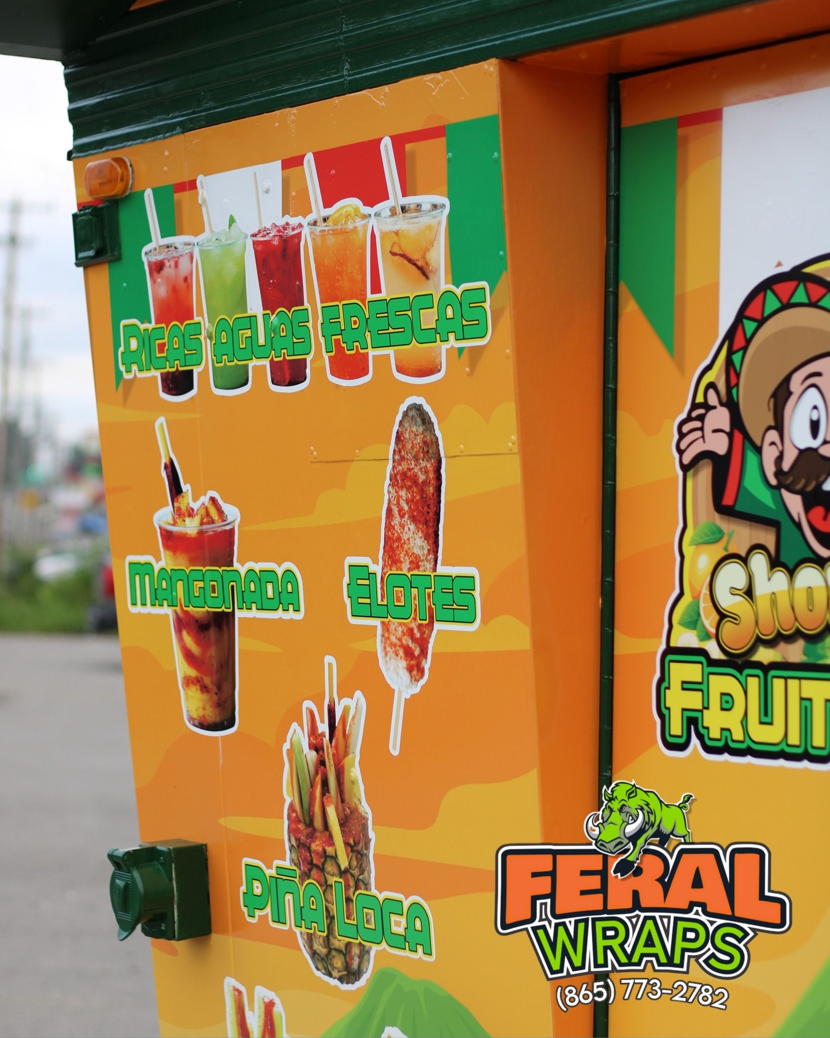 A food truck that says feral wraps on it