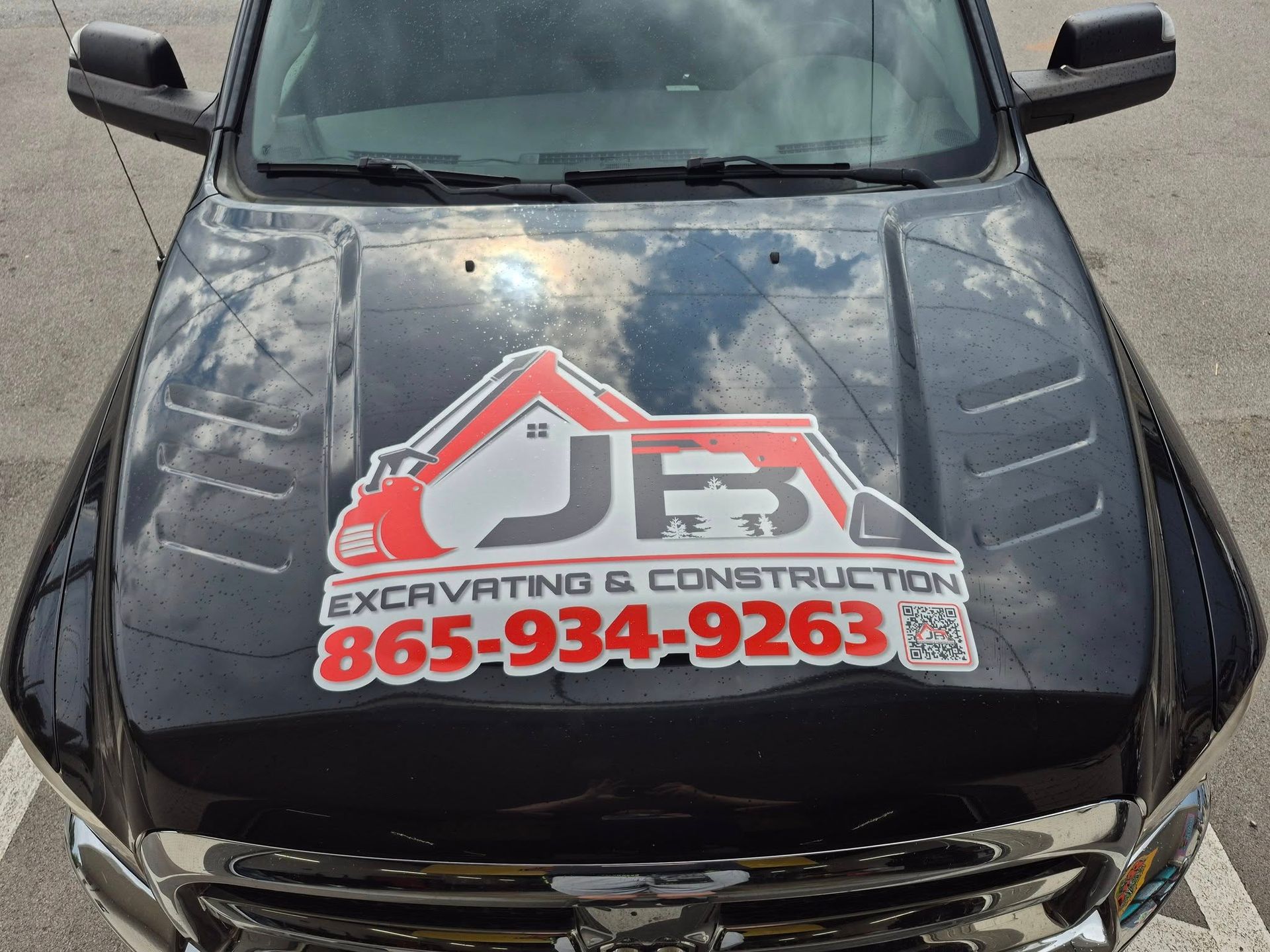 Black truck hood with JFB Excavating & Construction logo and phone number 865-934-9263.