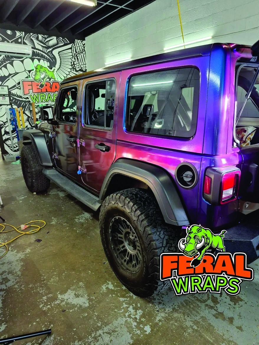 Custom wrapped Jeep Wrangler in a garage with 