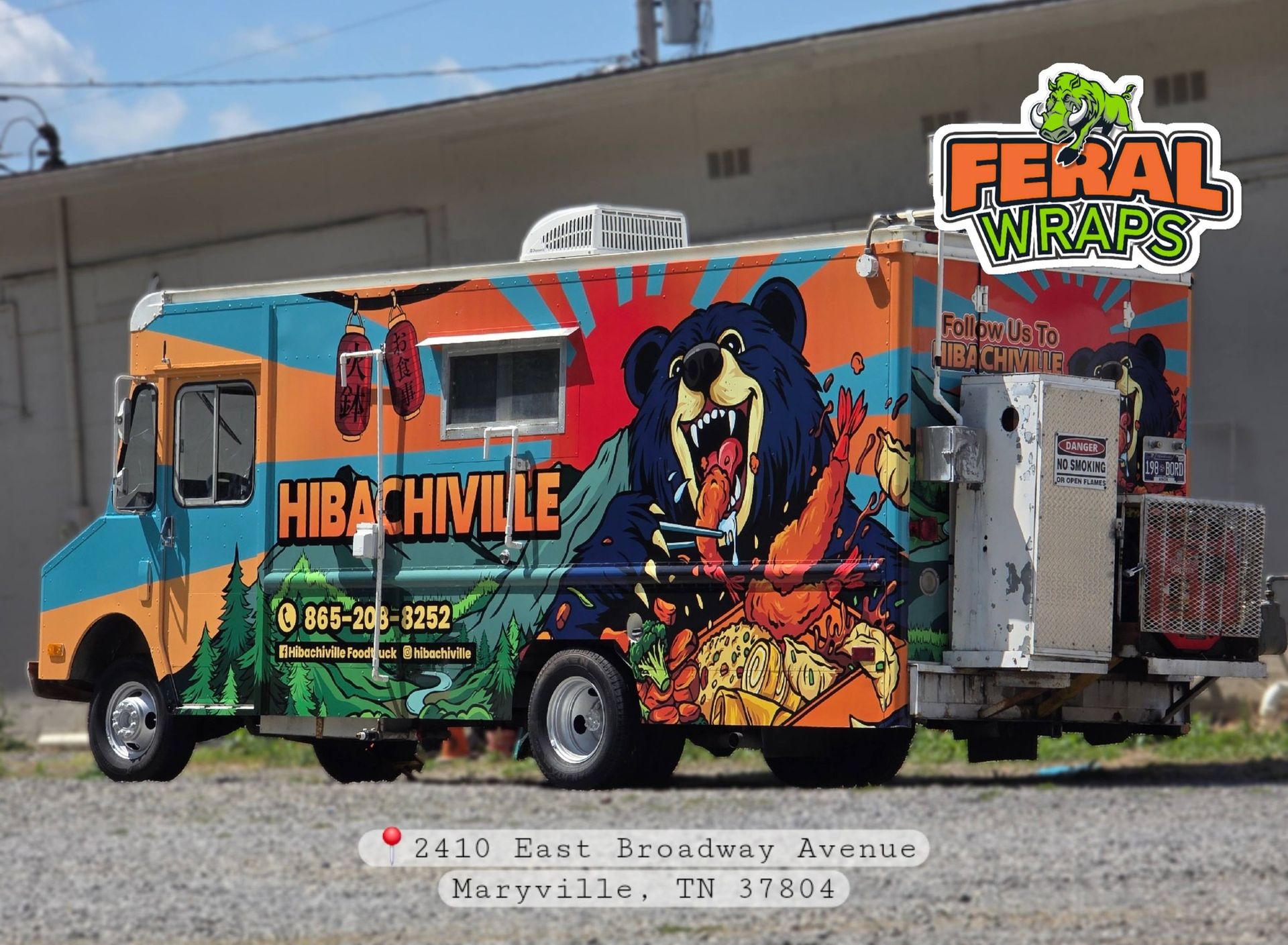 Colorful Hibachi Hues food truck with Feral Wings logo parked beside a building
