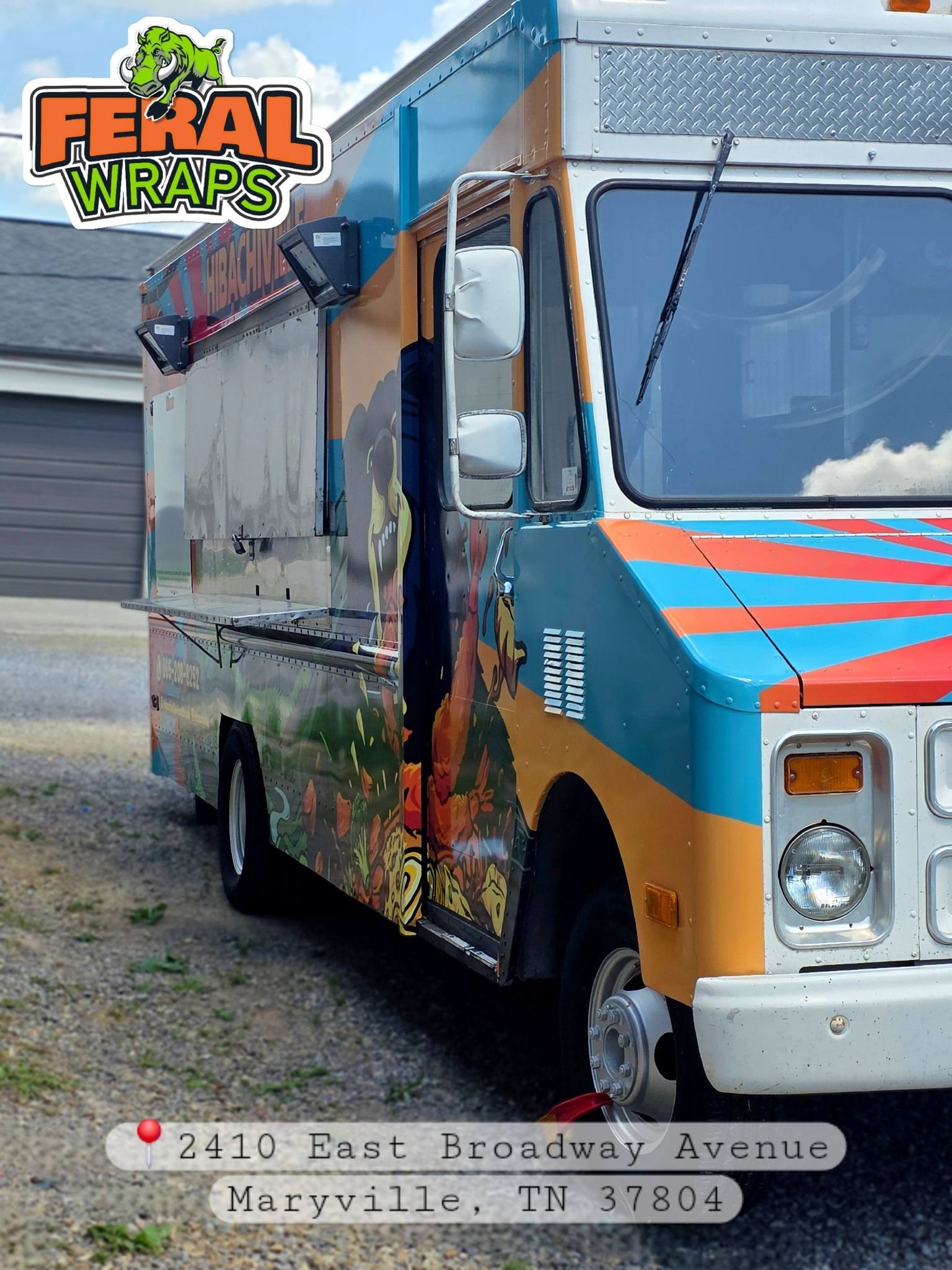 Colorful Feral Wraps truck parked outdoors beside a building, with orange, blue, and white graphics.