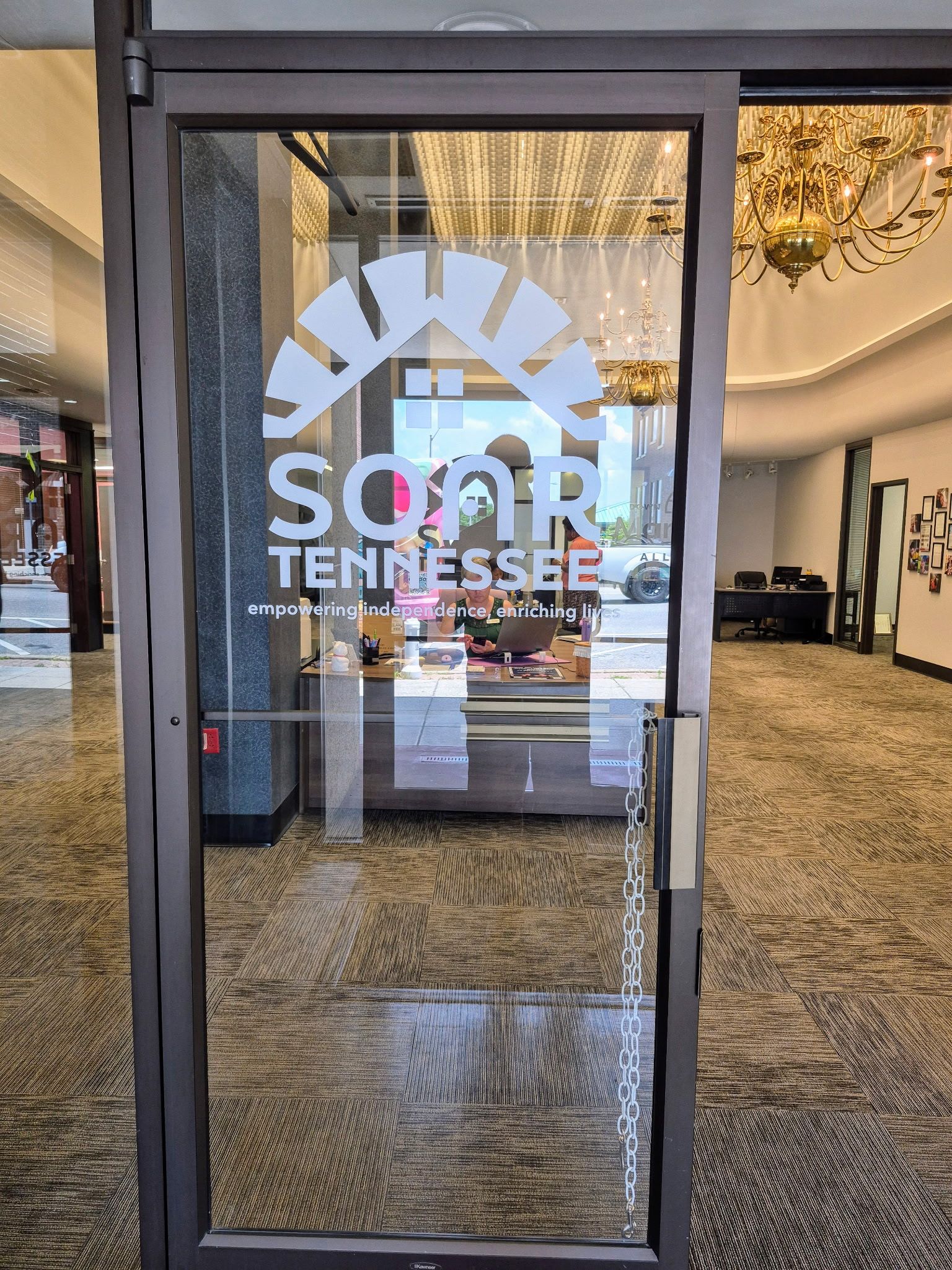 A glass door with a sign on it that says soar tennessee.