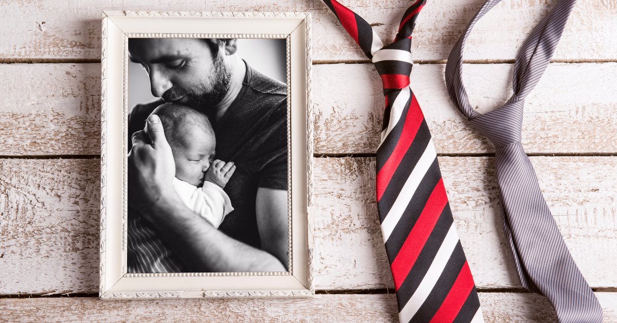 Proud Father holding his new born baby in celebration of Father's Day.