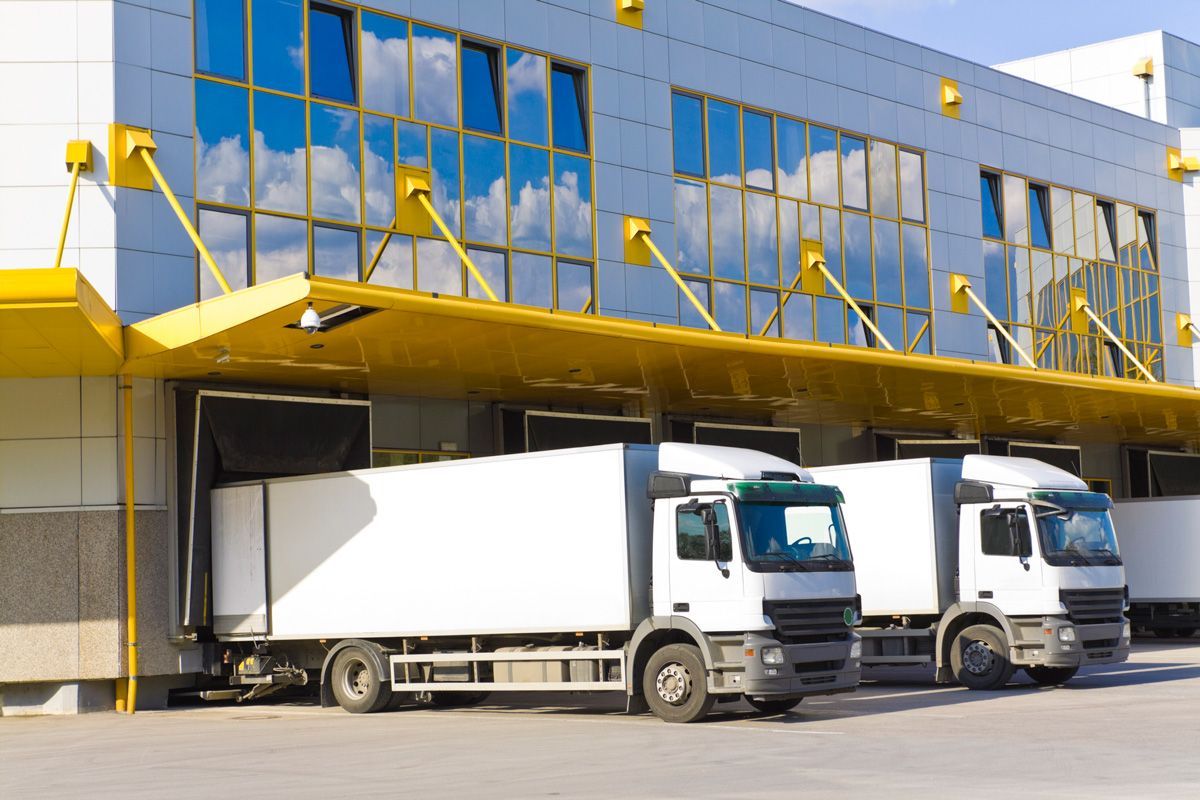 Trucks in Front of Modern Loading Docks — San Antonio, TX — C. M. Ruffo General Insurance Trucks in Front of Modern Loading Docks — San Antonio, TX — C. M. Ruffo General Insurance