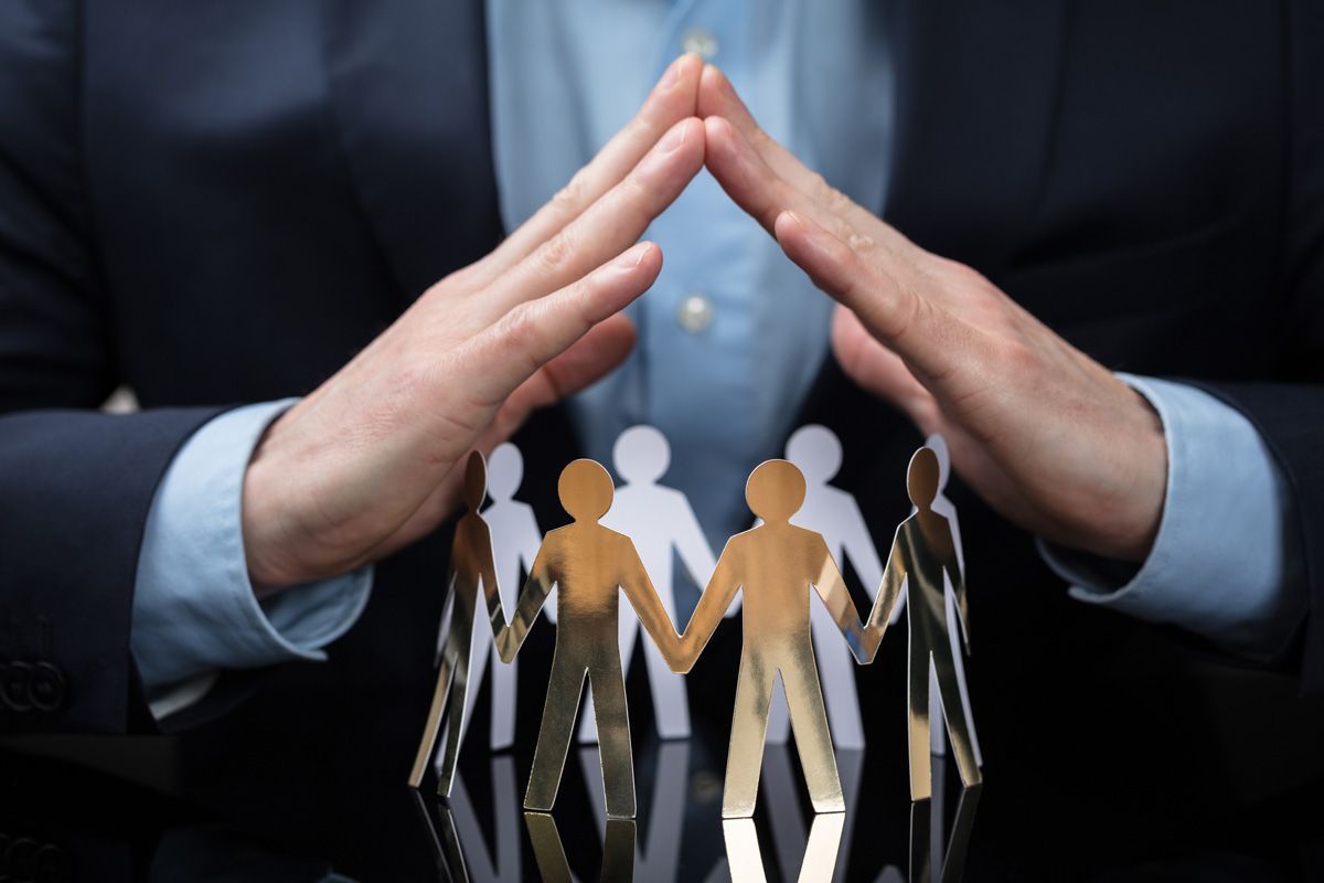 Businessperson Protecting Paper Cut Out People — San Antonio, TX — C. M. Ruffo General Insurance Businessperson Protecting Paper Cut Out People — San Antonio, TX — C. M. Ruffo General Insurance