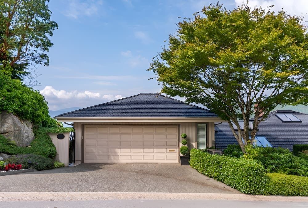 A House With A Garage And A Tree In Front Of It — Brunswick Valley Door Centre in Main Arm, NSW