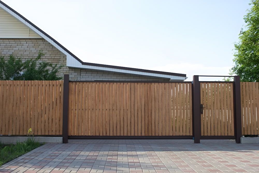 A Wooden Fence With A Gate In Front Of A House — Brunswick Valley Door Centre in Mullumbimby, NSW