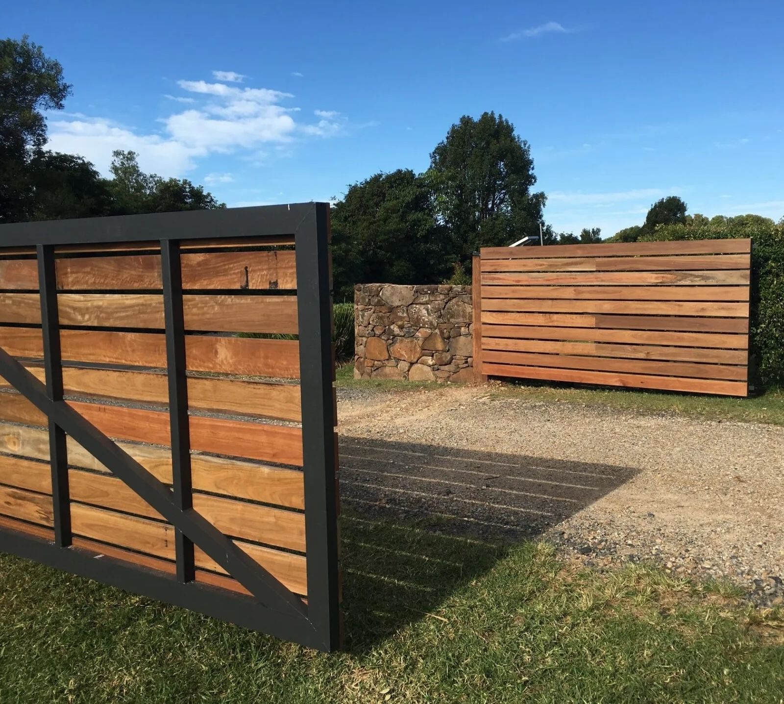 Large timber gates with a black frame