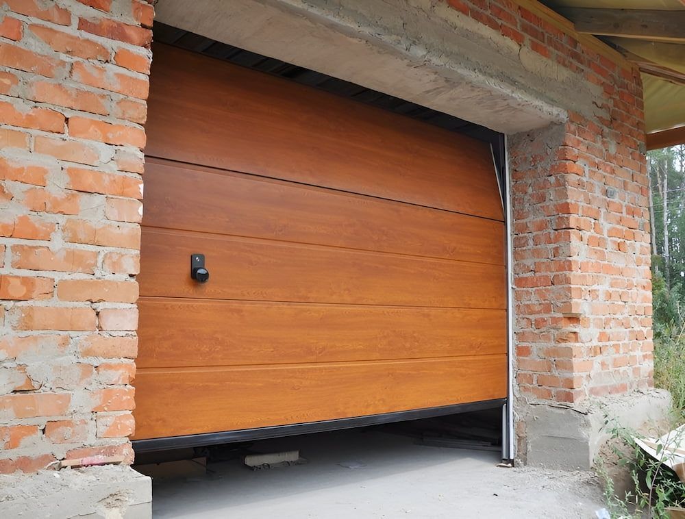 A Wooden Garage Door Is Open In A Brick Building — Brunswick Valley Door Centre in Mullumbimby, NSW