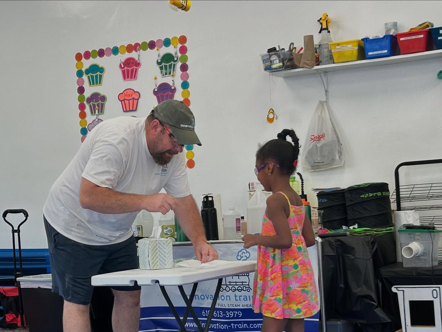vince shows a student what to do for the experiment