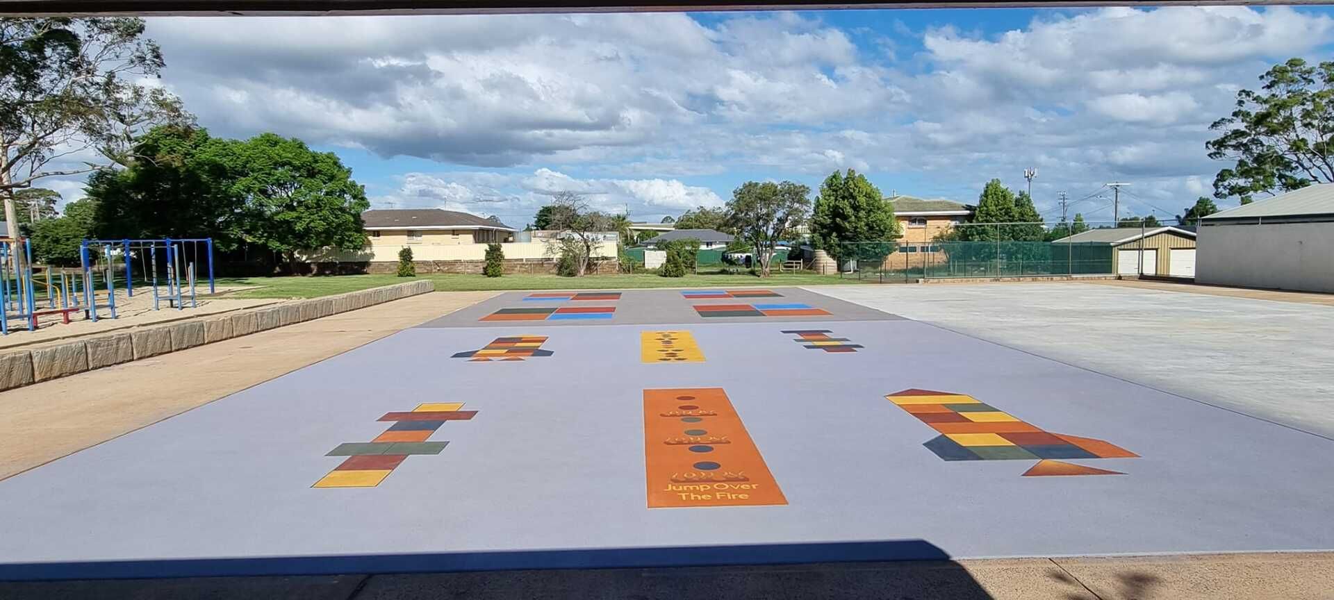 A Large Painted Play Area With Colorful Blocks and an Open Sky — SRS Concreting In Glenvale, QLD