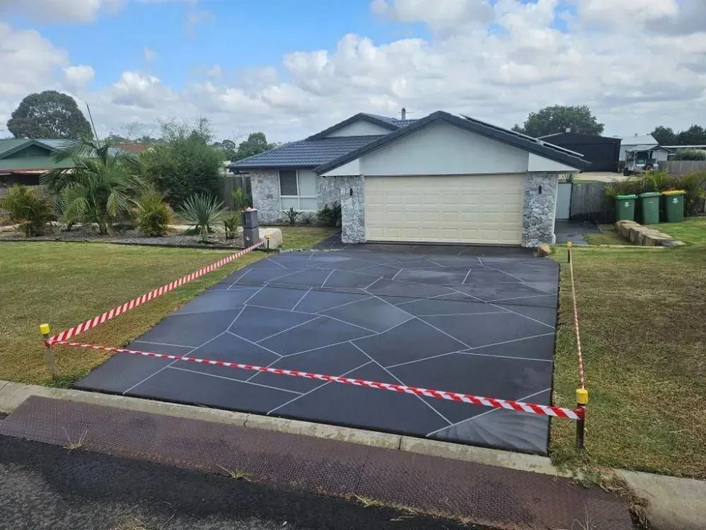 Driveway of a House With Decorative Geometric Design, Blocked Off With Caution Tape — SRS Concreting In Toowoomba, QLD