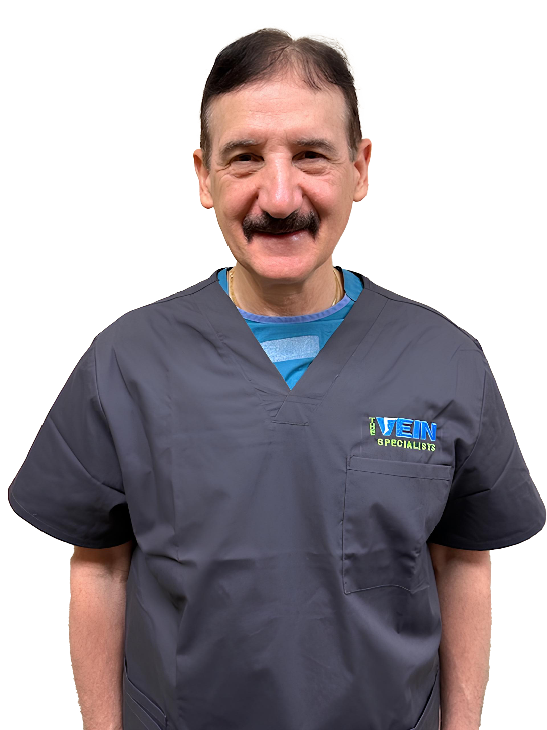 A man with a mustache is wearing a gray scrub top and smiling.