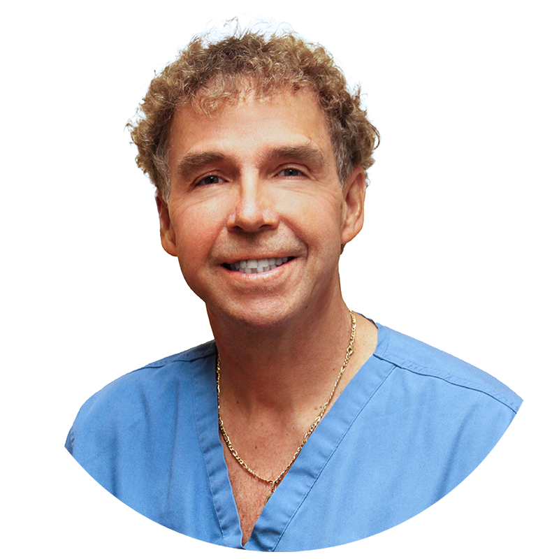 A man with curly hair is wearing a blue scrub top and a gold chain around his neck