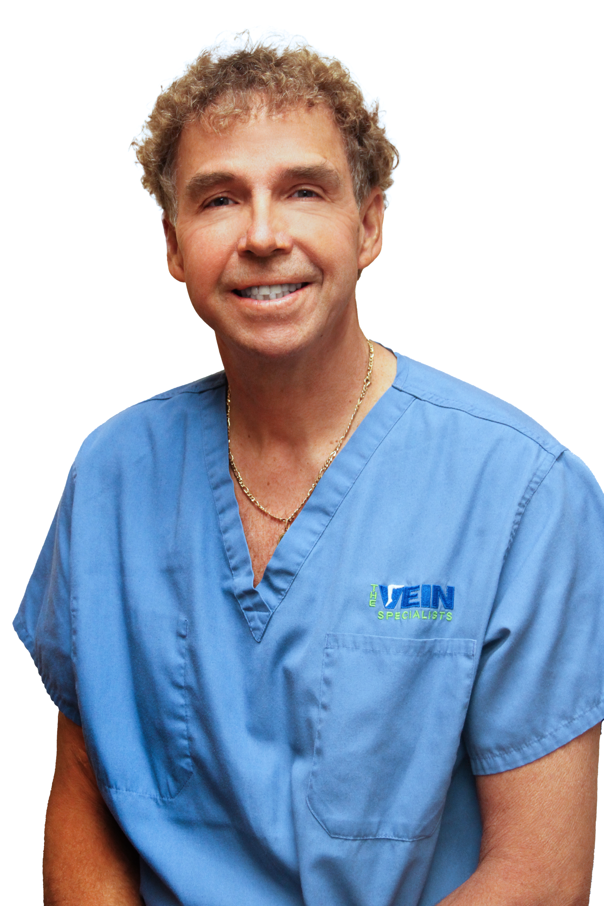 A man wearing blue scrubs smiling.