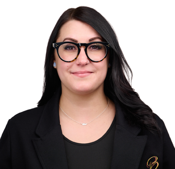A woman wearing glasses and a black jacket is smiling for the camera.