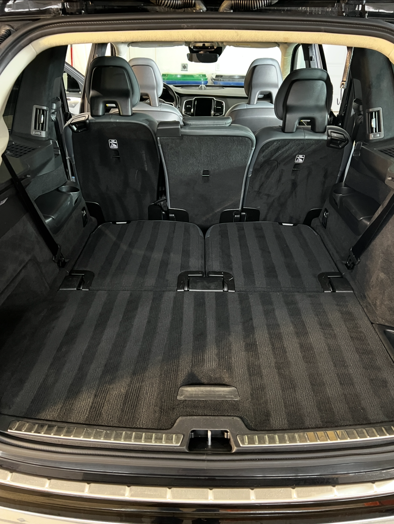 The back of a car with the trunk open and the seats folded down.