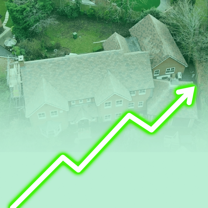 Aerial view of a house with a green arrow trending upwards, suggesting rising property value.
