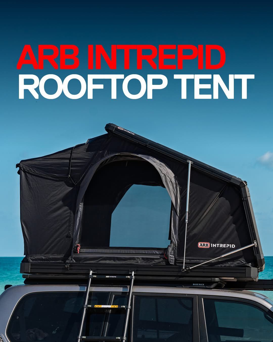 ARB Intrepid rooftop tent on a vehicle, black with ladder, under a blue sky — Ol Mate 4x4 in Tuggerah, NSW