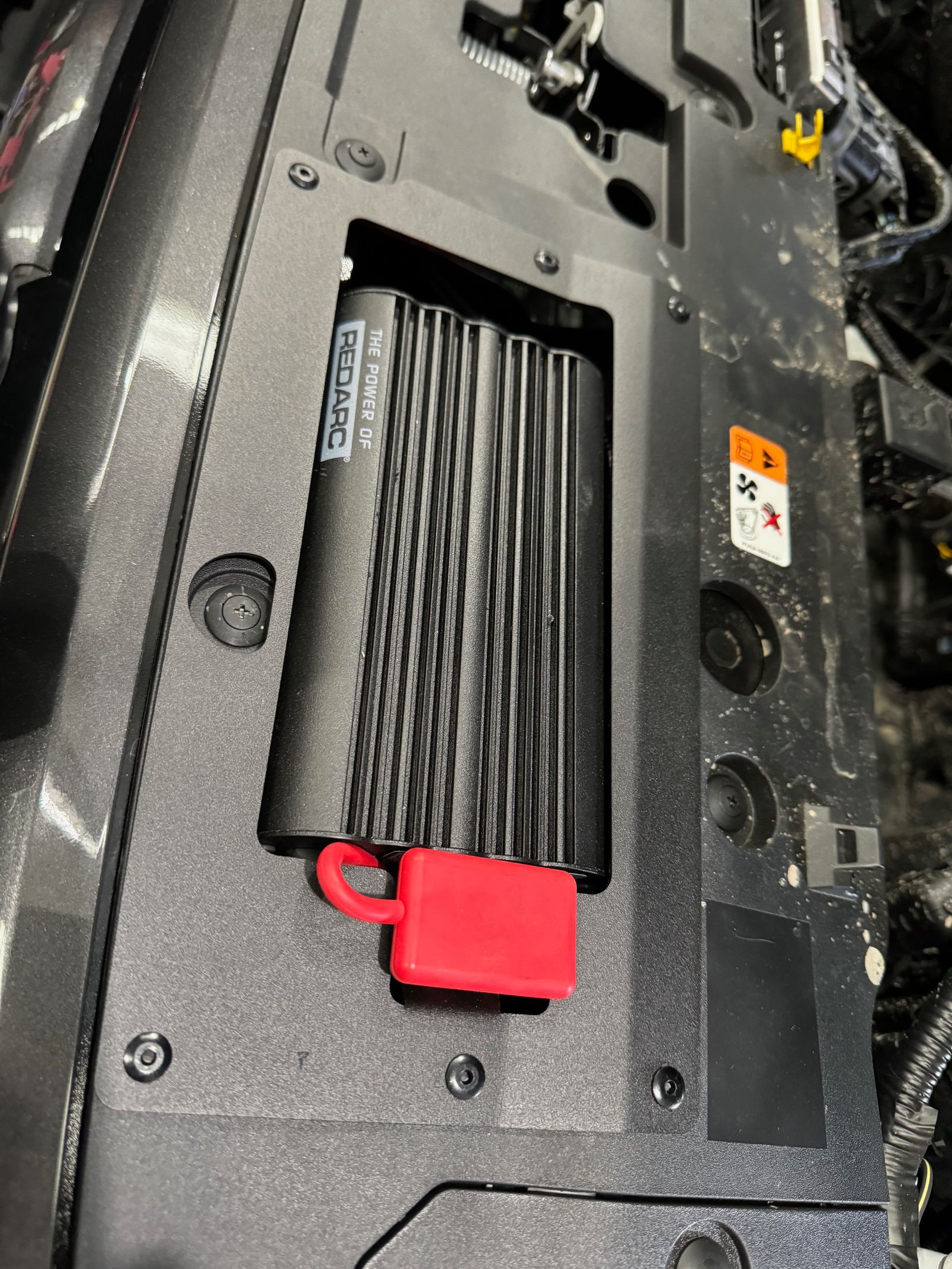 Black electronic module with red connector mounted inside a vehicle compartment — Ol Mate 4x4 in Tuggerah, NSW