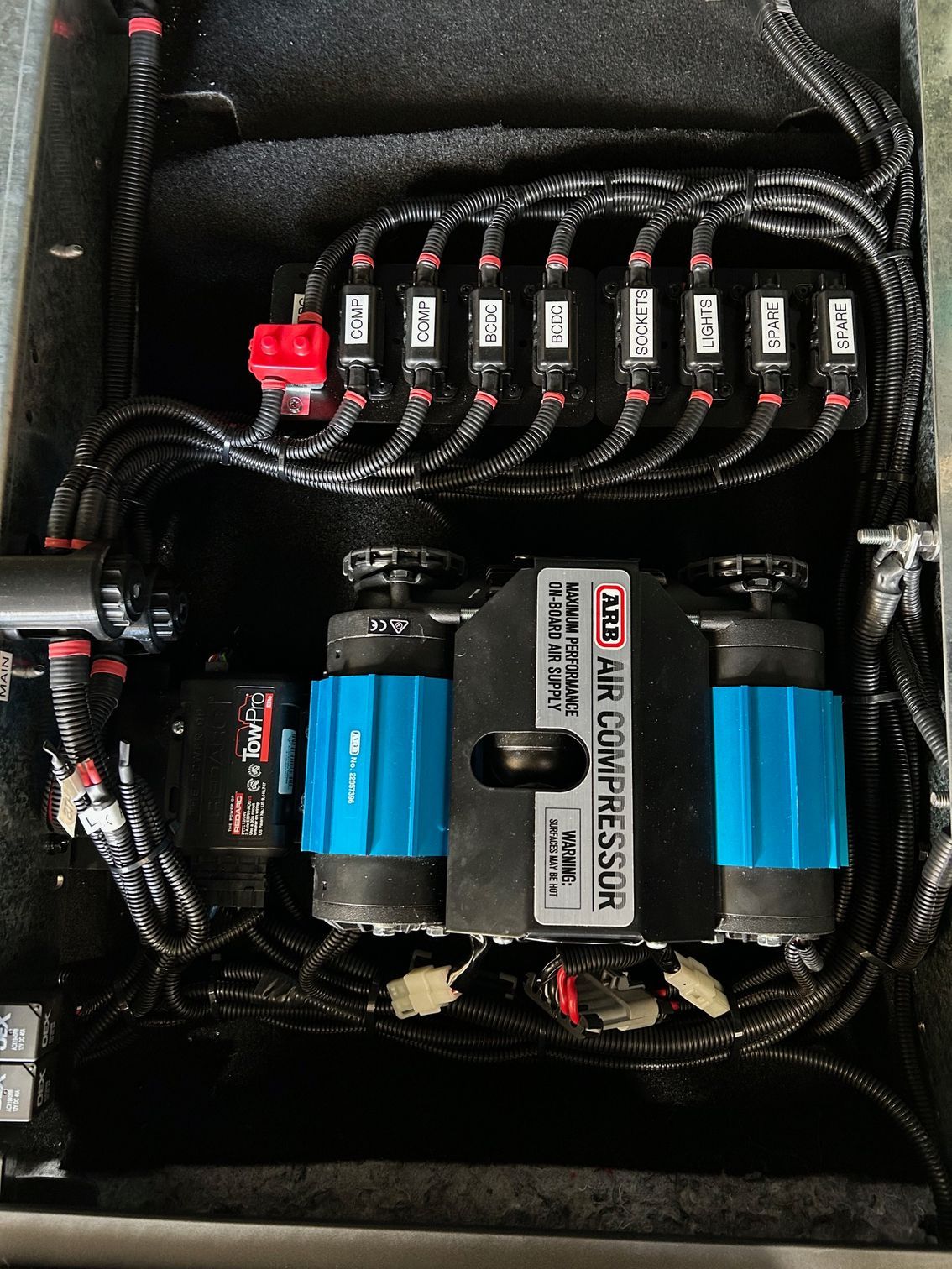 Neatly wired battery and fuse panel inside a compact black electronics case — Ol Mate 4x4 in Tuggerah, NSW