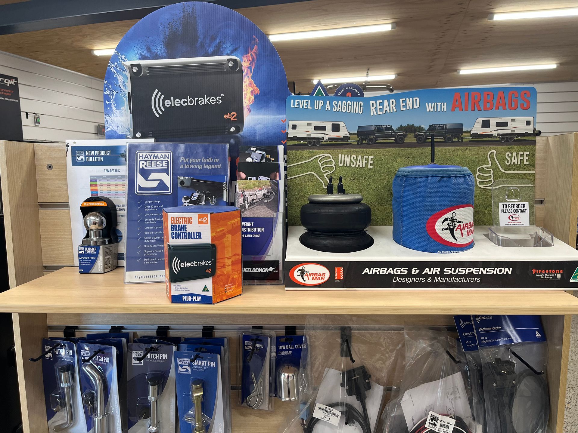 Airbus-branded display with hats, beanies, and gear arranged on a store shelf — Ol Mate 4x4 in Tuggerah, NSW