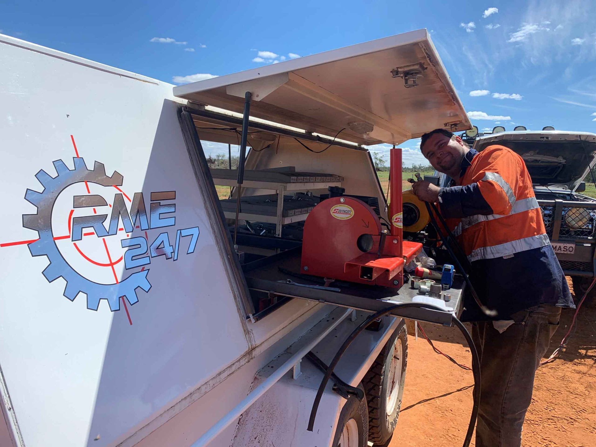 A Man Worker Smiling And Hydraulic Hose — Hydraulic Hose Services in Warren, NSW