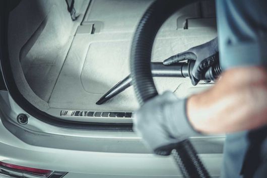 Men Vacuuming His Car Inside Vehicle Cargo Space