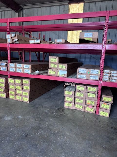 Warehouse shelves stacked with colorful boxed goods on a concrete floor
