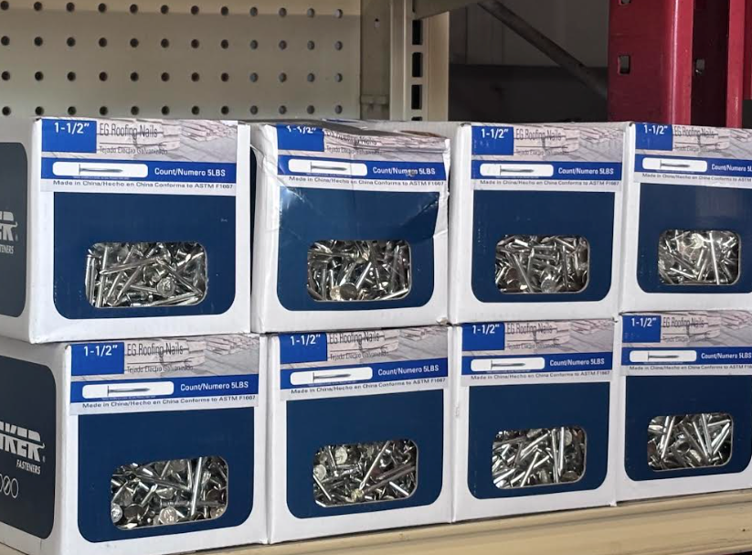 Blue storage boxes of assorted screws and fasteners on a warehouse shelf