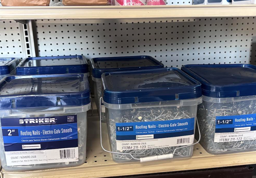 Blue plastic storage bins on a store shelf with labels and clear lids
