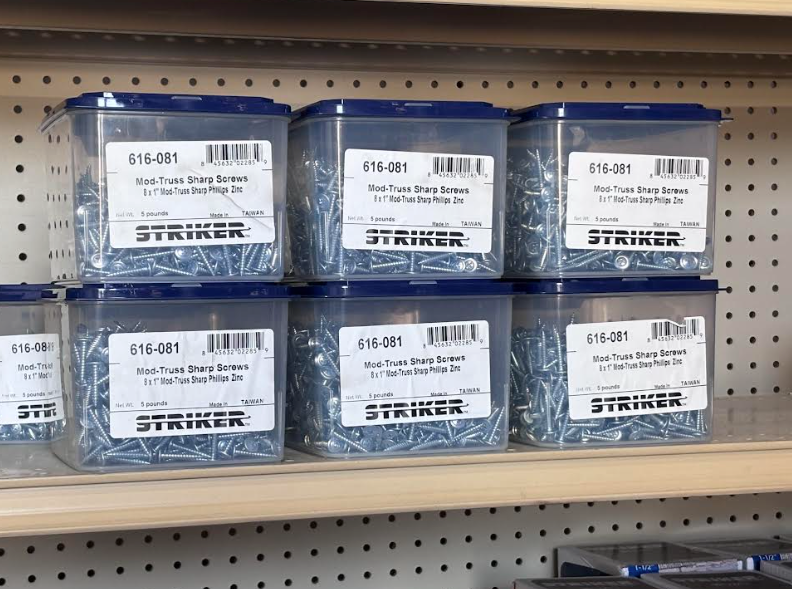 Clear plastic storage bins with white labels on a store shelf.