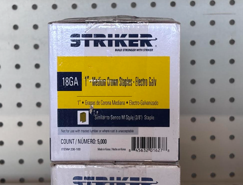 Close-up of Striker 18-gauge narrow crown staples box on a pegboard store shelf