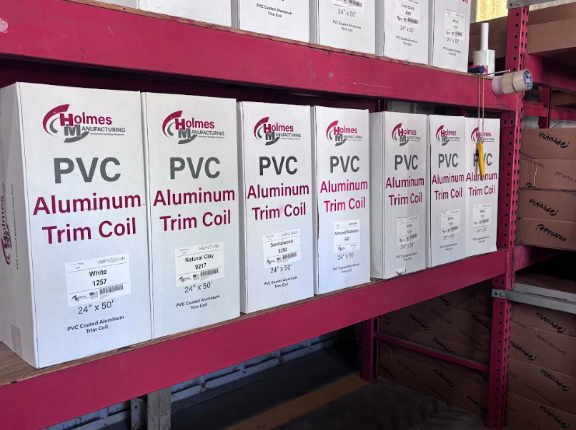Shelves of PVC and aluminum trim coil boxes in a warehouse aisle