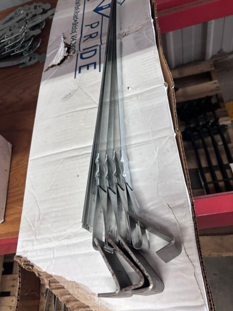 Metal bent rods stacked on a cardboard box in a warehouse